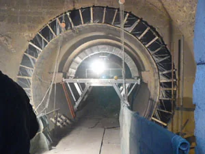 Bricking machine working inside a rotary kiln at a construction site